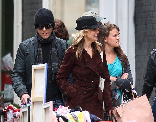 Kyra Sedgwick brown trenchcoat, black hat